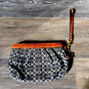 Coach wristlet with brown leather opening